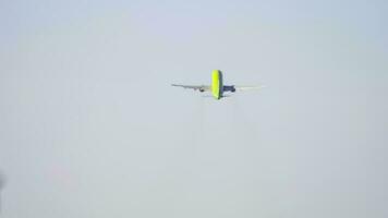 Passenger airplane takes off against the blue sky with clouds. Rear view, the jet plane is gaining altitude. Departure of the airliner video