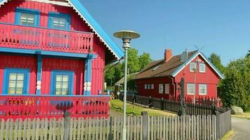 Nida, Lithuania - 7th june, 2023 - beautiful traditional lithuanian red wooden countryside houses in Nida, Curonian spit. Unesco world heritage site. Lithuania cultural heritage video