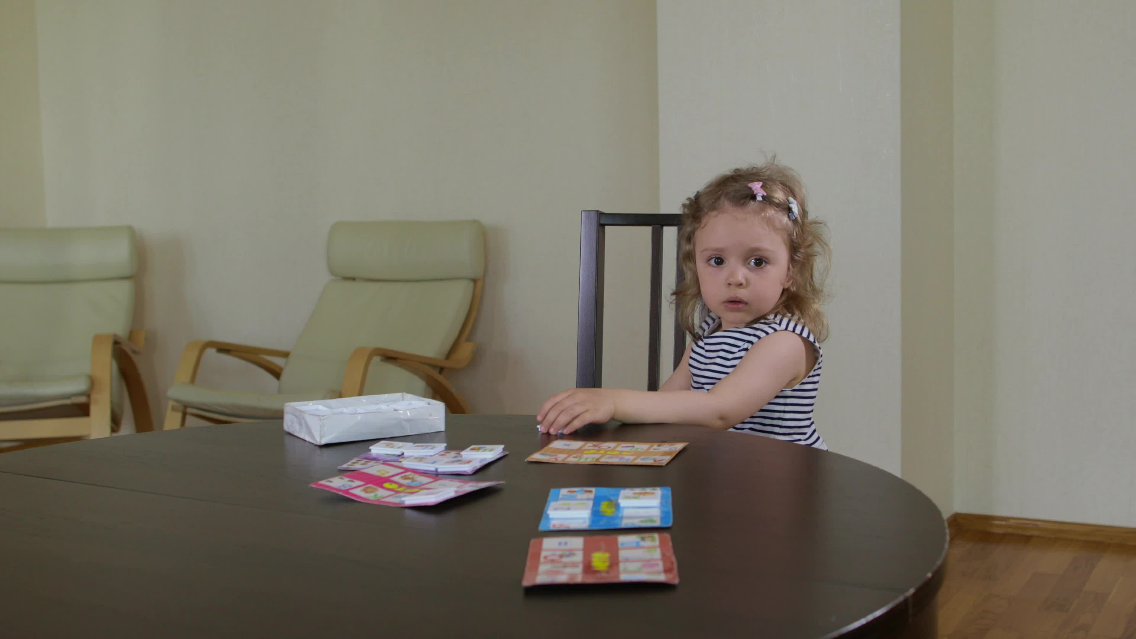 Young mother invites her daughter to play table game at the table 25107845 Stock Video at Vecteezy