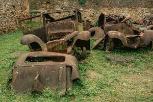 Old rusty cars left behind in Oradour-sur-Gllane, France. photo