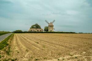 Moulin de pierre, old windmill in Hauville, France. photo