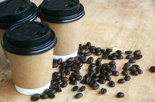 Takeaway coffee cup surrounded with coffee beans with customizable space for text or ideas photo