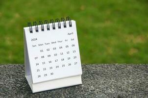 April 2024 table calendar with customizable space for text. Copy space. photo