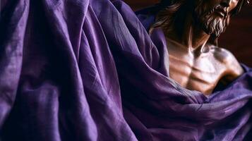Status of Jesus Christ covered with purple shawl. Lent season, Holy week and Good friday concept photo
