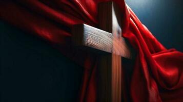 Wooden Cross of Jesus covered with red shawl. Lent season, Holy Week and Good Friday concept photo