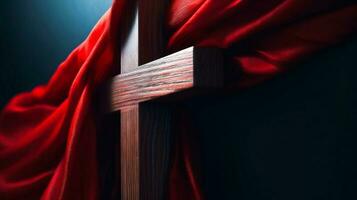 Wooden Cross of Jesus covered with red shawl. Lent season and Religion concept photo