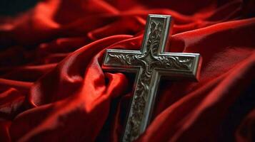Metal Holy Cross on red shawl cover background. Lent season, Holy week and Good friday concept photo