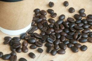 Takeaway cup surrounded by coffee bean with customizable space for text. Copy space and coffee concept photo