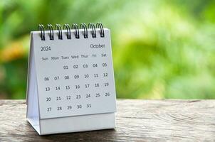 October 2024 white table calendar with customizable space for text. Calendar and copy space concept photo