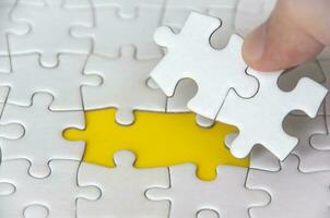 Hand holding separated jigsaw puzzle with customizable space for text. Copy space. photo