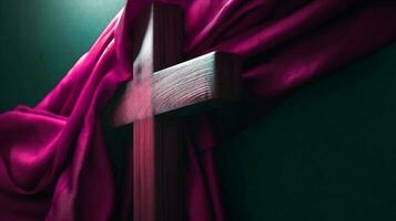 Wooden Cross of Jesus covered with purple shawl. Lent season, Holy week and Good friday concept photo