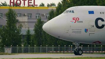 NOVOSIBIRSK, RUSSIAN FEDERATION JUNE 10, 2020 - Close up side view of Boeing 747 Cargolux taxiing at Tolmachevo airport. Freight transport carrier video