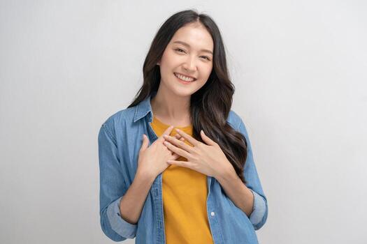 Smiling positive, attractive asian young woman wearing casual dress, portrait of beautiful brunette her with long black hair, feeling happy looking at camera standing isolated on white background. photo
