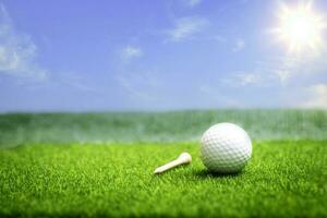Golf ball close up on tee grass on blurred beautiful landscape of golf background. Concept international sport that rely on precision skills for health relaxation. photo