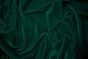 Green velvet fabric texture used as background. Peacock color panne fabric background of soft and smooth textile material. crushed velvet .luxury emerald tone for silk. photo