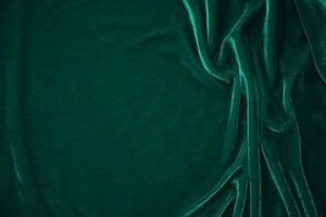 Green velvet fabric texture used as background. Peacock color panne fabric background of soft and smooth textile material. crushed velvet .luxury emerald tone for silk. photo