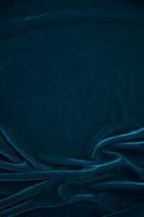 Blue velvet fabric texture used as background. Peacock color panne fabric background of soft and smooth textile material. crushed velvet .luxury navy tone for silk. photo