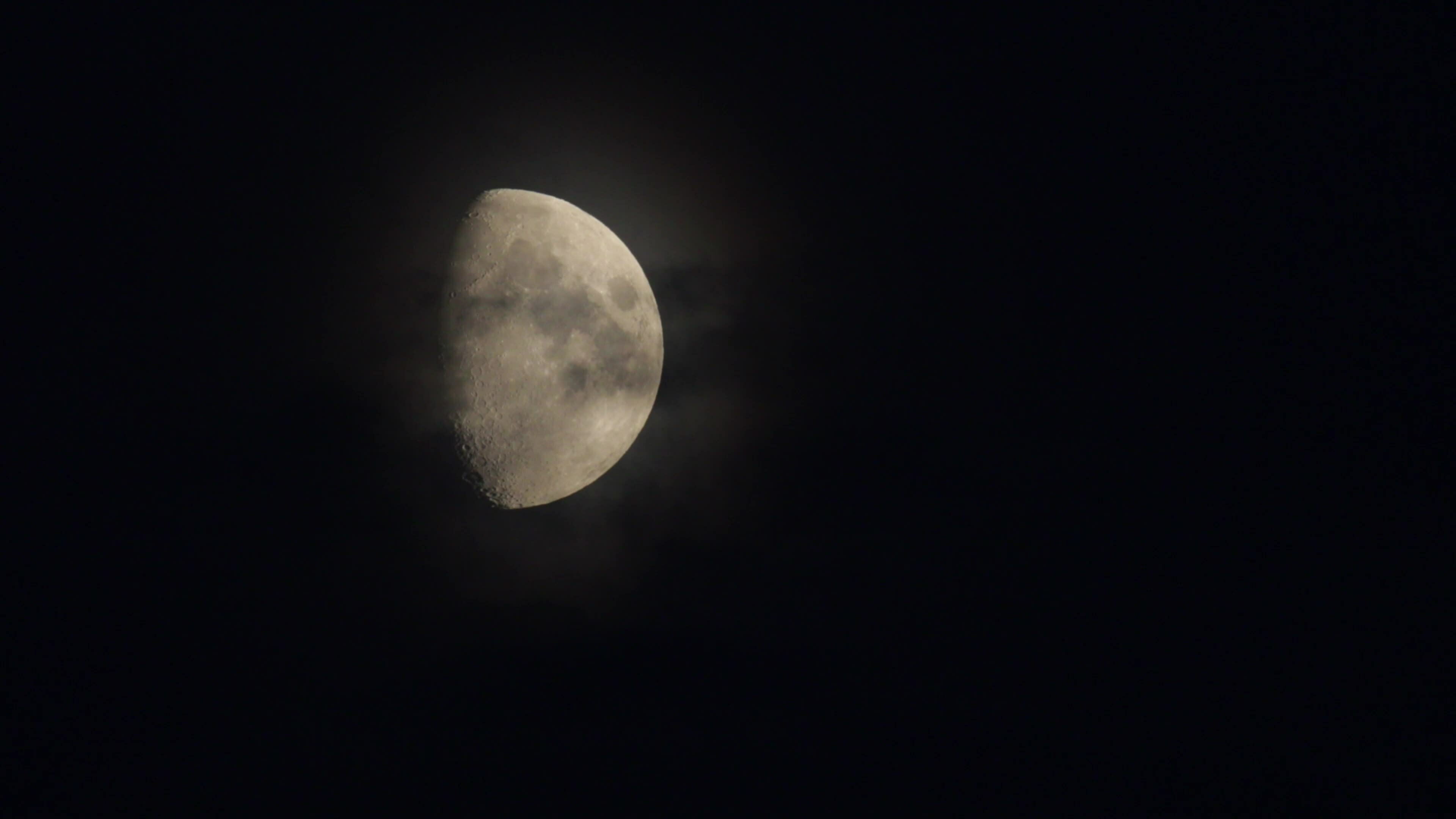 First quarter moon phase in the sky. Recorded in 4k