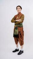 Asian man wearing typical, traditional Thai dress with identity Thai culture stand with arms crossed isolated on white background photo