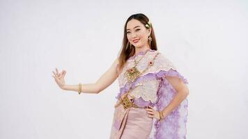 Luxury portrait of a beautiful Thai woman in traditional thai costume posing thai dance isolated on white background photo