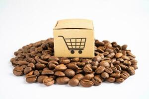 Box with shopping cart logo symbol on coffee beans, Import Export Shopping online or eCommerce delivery service store product shipping, trade, supplier concept. photo