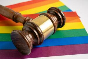 Gavel for judge lawyer on rainbow flag, symbol of LGBT pride month celebrate annual in June social of gay, lesbian, bisexual, transgender, human rights. photo