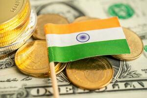 Stack of coins with India flag and US dollar banknotes. photo