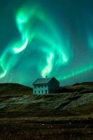 Aurora borealis and starry over nordic house on hill among the field in the night at Iceland photo