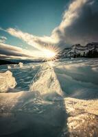 Sunset over cracked ice from frozen lake in winter photo
