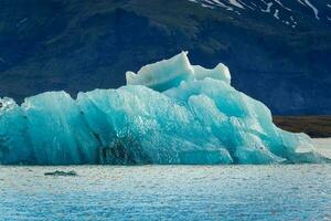 Abstract pattern of blue iceberg melting and floating in Jokulsarlon glacier lagoon on summer at Iceland photo