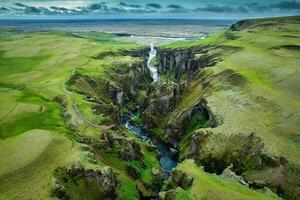 Stunning view of Fjadrargljufur canyon naturally eroded with Fjadra flowing through ravine in summer at Iceland photo