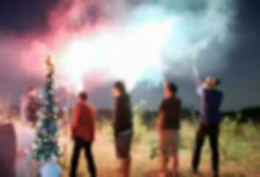 Blurred scene friend celebration playing sparkler photo