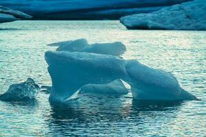 Abstract pattern of blue iceberg melting and floating in Jokulsarlon glacier lagoon on summer at Iceland photo