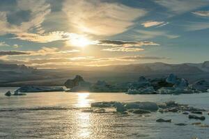 Jokulsarlon glacier lagoon with iceberg melting in the sunset at Iceland photo
