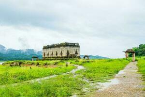 Temple in dam and green field natural photo