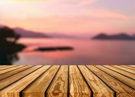 Wooden table top on colorful sky on the lake in countryside at evening photo