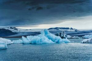 Blue iceberg floating in Jokulsarlon glacier lagoon at Vatnajokull national park, Iceland photo