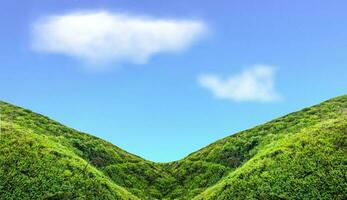 Green mountain slope with cloud in blue sky photo