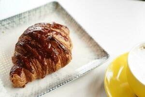 fresh baked croissant on plate with copy space photo