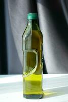 bottle of olive oil on table photo