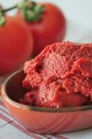 Tomato paste with ripe tomatoes. photo