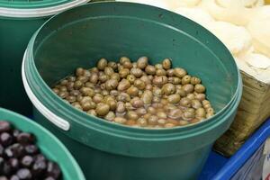 Buckets of olives for sale street food market photo