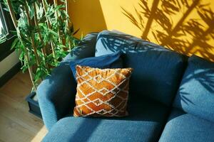 modern blue sofa with yellow color pillows in living room at home photo