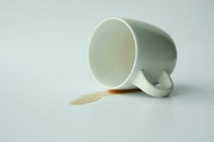 cup of coffee spilled on white background photo