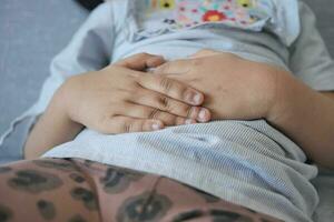 child suffering stomach pain close up. photo