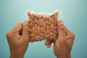men holding a almond nut packet photo