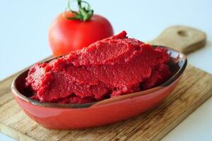 Tomato paste with ripe tomatoes. photo