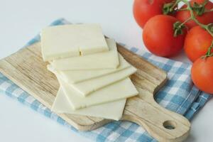 Slicing cheese into pieces closeup, photo