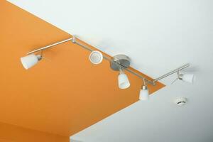 many ceiling light hanging in a room , photo