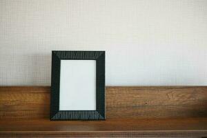 empty frame on table against a wall photo